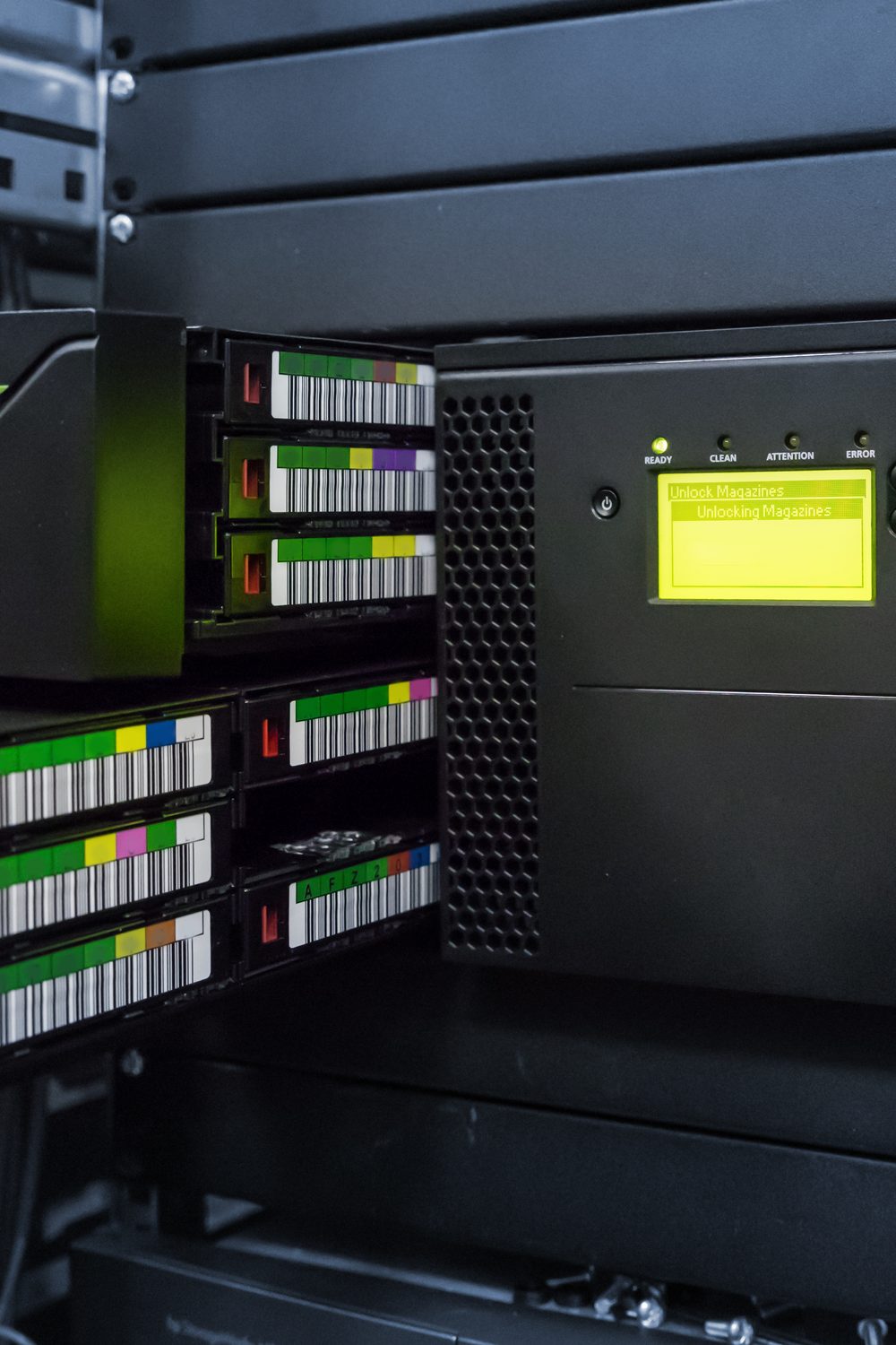 LTO tape autoloader in a server rack with its tape magazines open